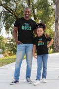 Dad and daughter wearing matching black t-shirts that say “The Boss” and “The Real Boss”