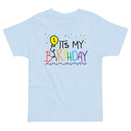 Light blue t-shirt with colorful 'It's My 1st Birthday' design on a white background