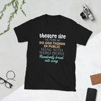 Black t-shirt with colorful Theatre Life This means we do odd things in public hang with weird people randomly break into song text on a light gray surface with a camera and glasses.