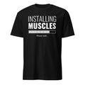 Black t-shirt with white text 'Installing Muscles Please wait...' on a white background