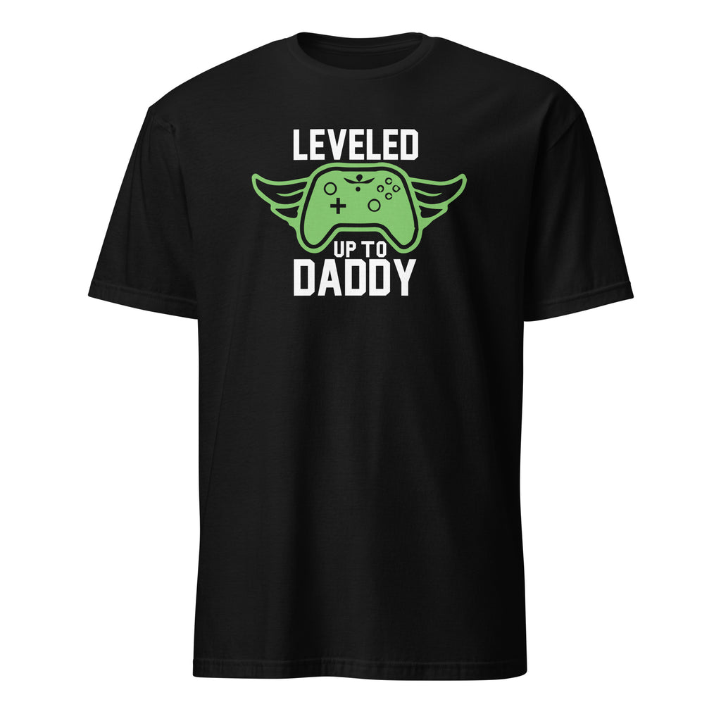 black graphic t-shirt that reads "Leveled Up to Daddy," displayed as a flat lay or lifestyle product photo — fun new dad gift for gamer dads and baby showers.
