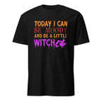 A black short-sleeve crewneck t-shirt with a colorful graphic on the chest that reads 'TODAY I CAN BE MOODY AND BE A LITTLE WITCH' in orange, red, and purple dripping fonts, alongside a purple witch silhouette.