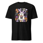 A black short-sleeve crewneck t-shirt featuring a colorful Halloween graphic on the front with the text 'SWEET & SPOOKY' surrounding a cartoon ghost, spider, pumpkin, and flowers.