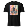 A black short-sleeve crewneck t-shirt featuring a colorful graphic print on the front. The graphic depicts a cute black cat dressed as a witch sitting in a flower-filled wagon next to a white ghost, set against a background of vertical pastel stripes.