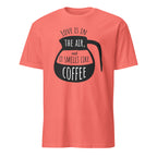 Coral t-shirt with black coffee graphic and "Love Is In The Air and It Smell Like Coffee" text on a white background