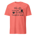 Coral t-shirt with "I Like Coffee Because It Gives Me The Illusion I Might Be Awake" text design on a white background
