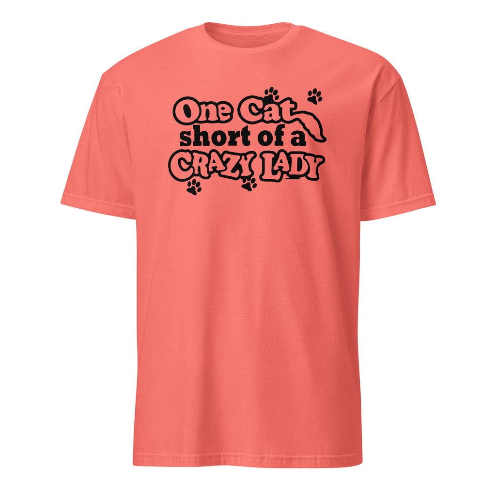 Coral t-shirt with black text 'One cat short of a crazy lady' on a white background