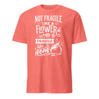 Coral t-shirt with white Not Fragile Like A Flower Fragile Like A Bomb text and graphic on a white background