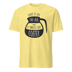 Yellow t-shirt with black coffee graphic and "Love Is In The Air and It Smell Like Coffee" text on a white background