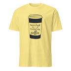 Cornsilk t-shirt with a coffee cup graphic and "I Never Laugh Until I've Had My Coffee" text on a white background