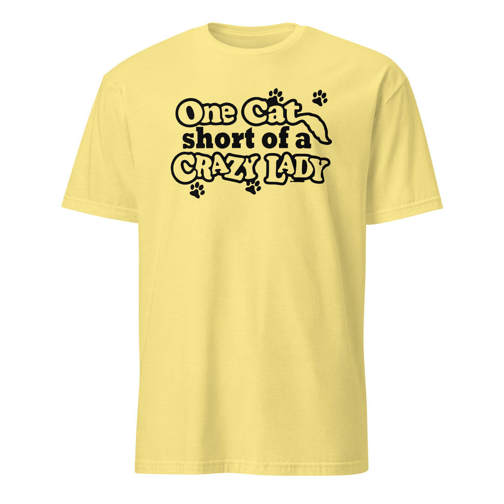 Yellow t-shirt with black text 'One cat short of a crazy lady' on a white background
