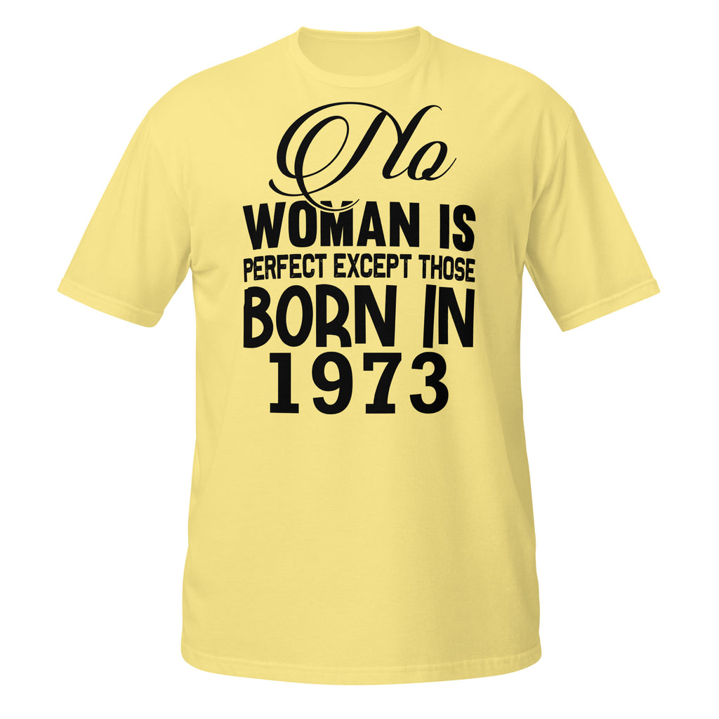 Yellow t-shirt with black text 'No woman is perfect except those born in 1973' on a white background