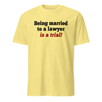 Yellow t-shirt with text 'Being married to a lawyer is a trial!' on a white background