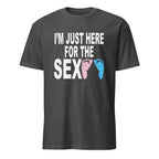 Dark Grey unisex t-shirt with bold black text reading "I'm Just Here for the Sex" displayed flat-lay, styled for a gender reveal party theme with pink and blue accents in the background