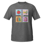 A dark heather gray short-sleeve t-shirt with a colorful graphic print on the chest. The graphic is divided into four square panels: a red apple holding a pencil, a yellow bow tie, books, and a pink backpack, all decorated with pastel borders.