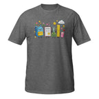 A dark heather gray short-sleeve t-shirt with a colorful cartoon graphic of school supplies (a blue backpack, a notebook, scissors, a ruler, and a pencil case) on the chest, displayed against a solid white background.