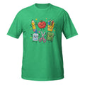 A green short-sleeve crewneck t-shirt featuring a colorful graphic of cute, anthropomorphic school supplies including a pencil, apple, colored pencils, sticky notes, scissors, and a notebook on a white background.