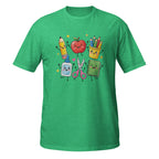 A green short-sleeve crewneck t-shirt featuring a colorful graphic of cute, anthropomorphic school supplies including a pencil, apple, colored pencils, sticky notes, scissors, and a notebook on a white background.
