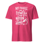 Pink t-shirt with white Not Fragile Like A Flower Fragile Like A Bomb text and graphic on a white background