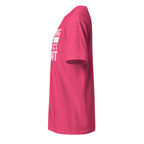 Pink t-shirt left side with white text on the front on a white background