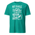 Teal t-shirt with white Not Fragile Like A Flower Fragile Like A Bomb text and graphic on a white background