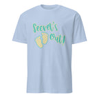 Light blue t-shirt with 'Secret's Out!' text and footprints on a white background