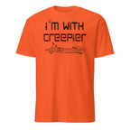 An orange short-sleeve crewneck t-shirt with a black graphic print on the front that reads 'I'm with creeper' above a line drawing of a skeletal arm pointing, shown on a plain white background.