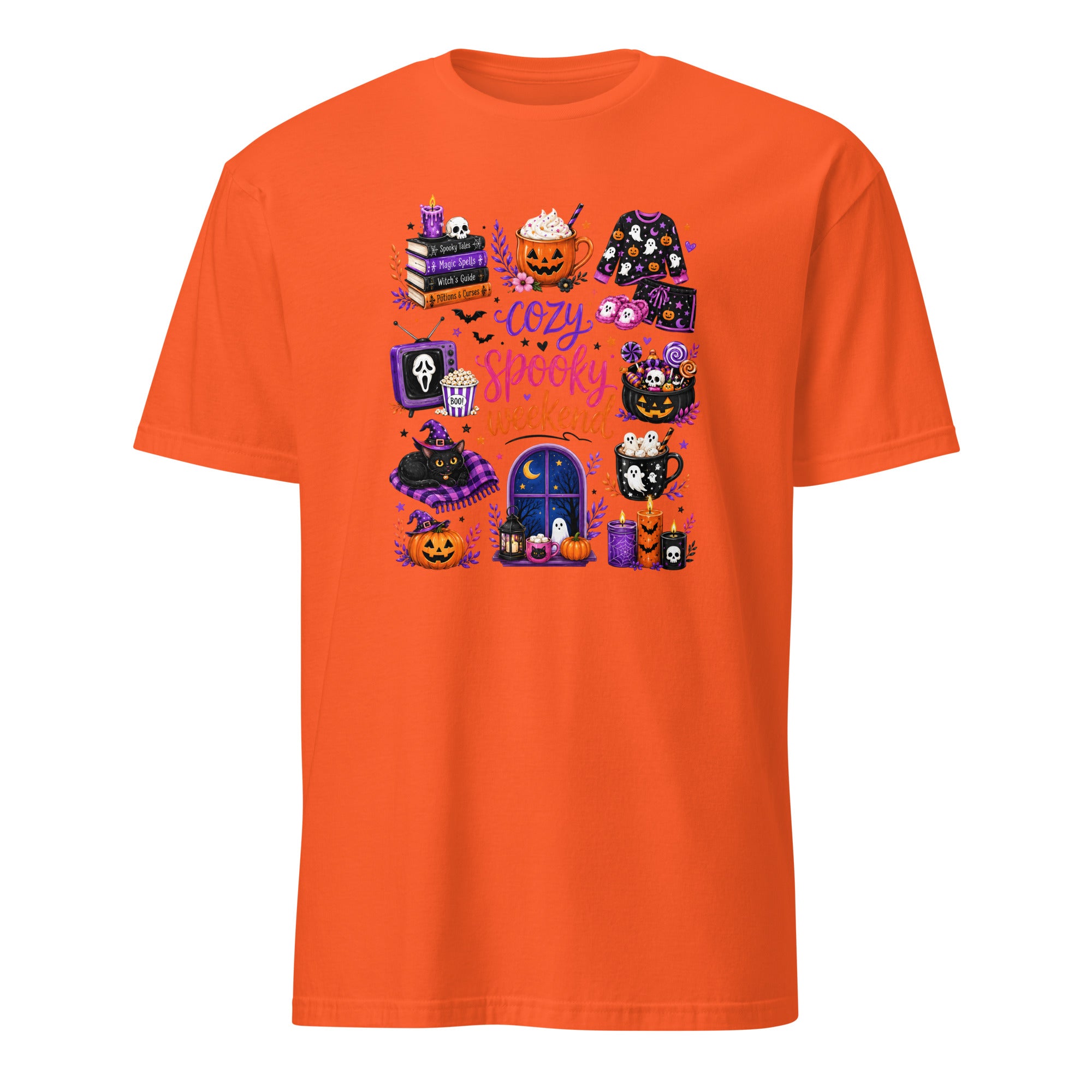 An orange short-sleeve crewneck t-shirt featuring a colorful graphic print on the front with various cute Halloween-themed illustrations, including pumpkins, a ghost, a mug, and a window, with the text 'Cozy Happy Halloween'.
