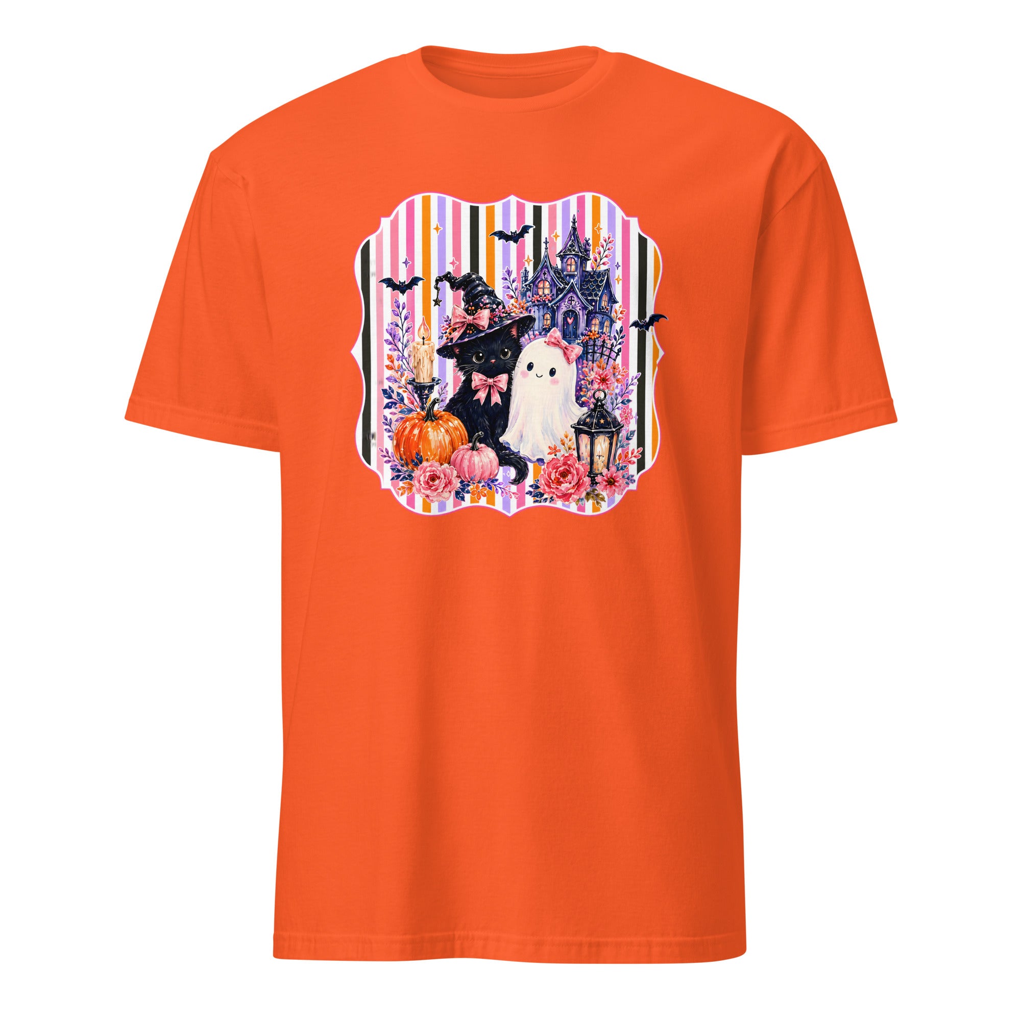 An orange short-sleeve crewneck t-shirt featuring a colorful Halloween-themed graphic print on the chest with a witch, ghost, castle, and pumpkins.