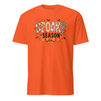 An orange short-sleeve crewneck t-shirt featuring a 'Spooky Season' graphic on the chest with Halloween-themed patterns and illustrations.