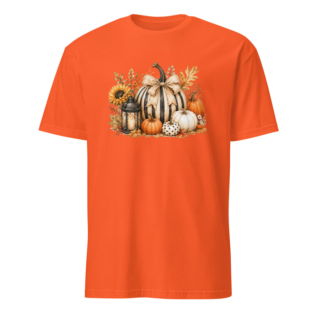 A bright orange short-sleeve crewneck t-shirt featuring a detailed autumn graphic on the chest with striped pumpkins, sunflowers, a lantern, and fall leaves.