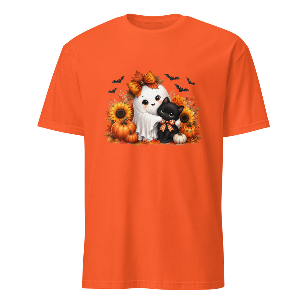 An orange short-sleeve crewneck t-shirt featuring a central graphic of a white ghost cat hugging a black kitten, surrounded by pumpkins, sunflowers, autumn leaves, and flying bats.