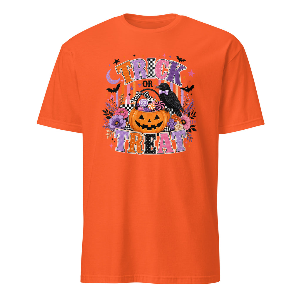 An orange short-sleeve crewneck t-shirt featuring a colorful 'Trick or Treat' Halloween graphic on the front, including a jack-o'-lantern, a raven, bats, and flowers, shown against a plain white background.