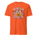 A bright orange short-sleeve crewneck t-shirt featuring a colorful graphic on the front with the text 'PUMPKIN QUEEN' surrounding a jack-o'-lantern pumpkin with a white bow and autumn flowers.