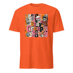 A bright orange short-sleeve crewneck t-shirt featuring a colorful graphic print on the front with the text 'Stay Creepy' and various Halloween-themed illustrations including sugar skulls, a skeleton hand, and a jack-o'-lantern.