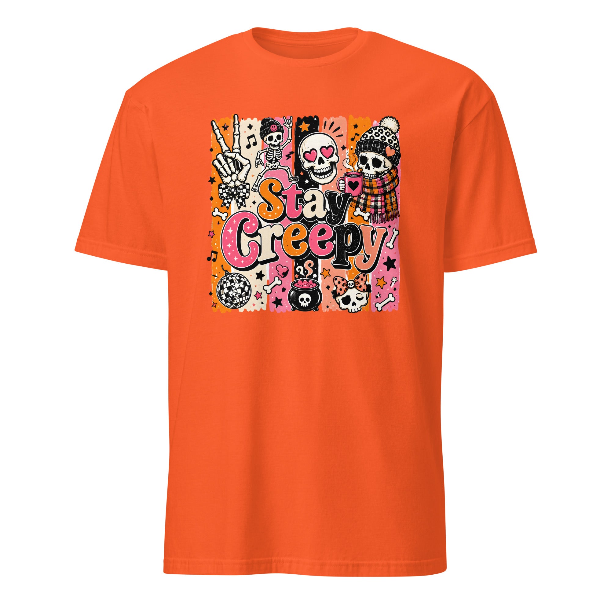 A bright orange short-sleeve crewneck t-shirt featuring a colorful graphic print on the front with the text 'Stay Creepy' and various Halloween-themed illustrations including sugar skulls, a skeleton hand, and a jack-o'-lantern.