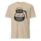 Beige t-shirt with black coffee graphic and "Love Is In The Air and It Smell Like Coffee" text on a white background