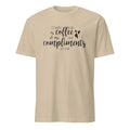 Sand t-shirt with text 'I'd rather take coffee than compliments just now' on a white background