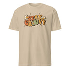 Sand t-shirt with 'Stay Groovy' text and flowers on a white background