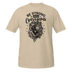 Beige t-shirt with black lion graphic and 'Be Strong and Courageous' text on a white background