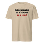 Beige t-shirt with text 'Being married to a lawyer is a trial!' on a white background