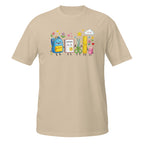 A beige short-sleeve crewneck t-shirt featuring a colorful cartoon graphic of school supplies (a blue backpack, notebook, scissors, ruler, and pencil) on the chest, displayed against a solid white background.
