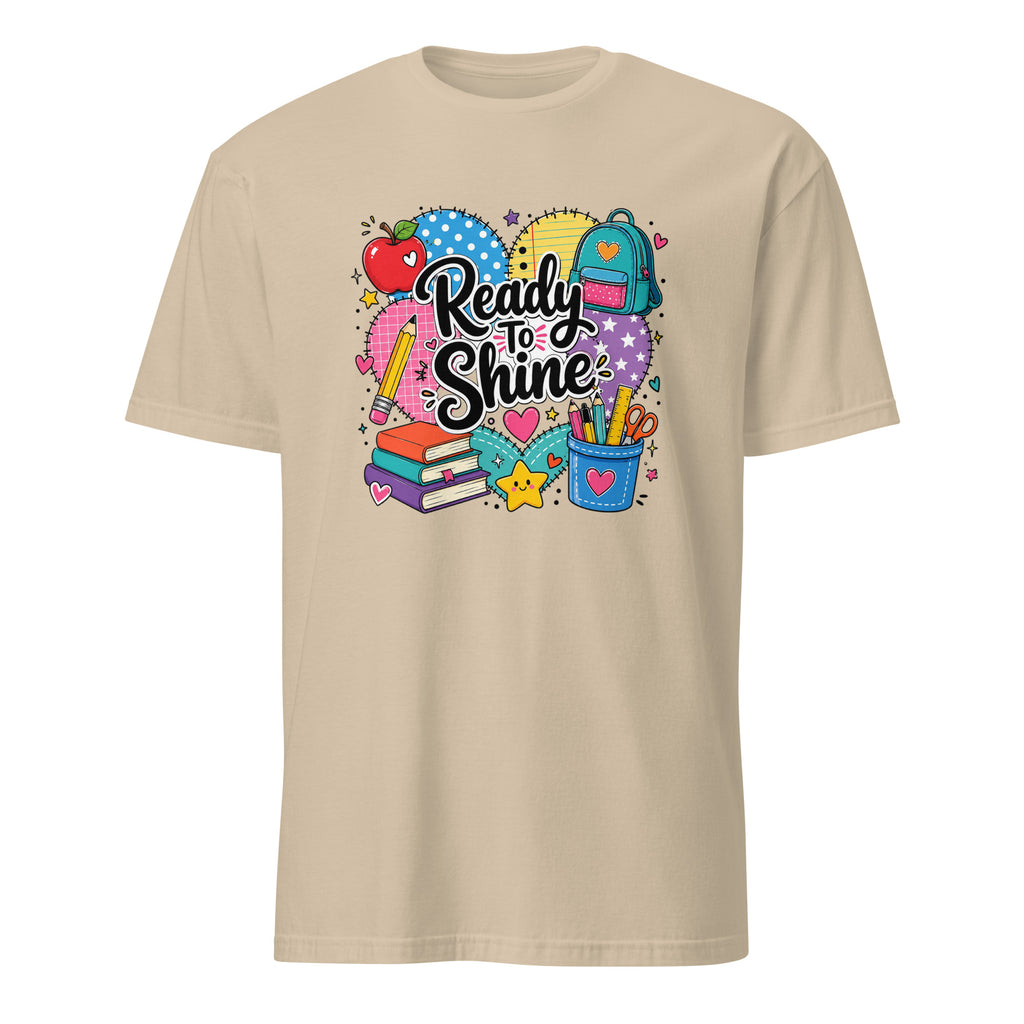 A beige short-sleeve crewneck t-shirt featuring a colorful graphic on the chest with school-themed illustrations and the text 'Ready to Shine'.