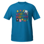 A bright blue short-sleeve t-shirt with a colorful graphic on the chest that reads 'make A Difference' surrounded by school-themed doodles like a lightbulb, flowers, a ruler, and notebooks.