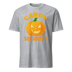 A sport grey short-sleeve t-shirt with a graphic of a smiling orange jack-o'-lantern pumpkin and the words 'CANDY SECURITY' in orange and yellow, shown on a plain white background.