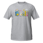 A heather gray short-sleeve crewneck t-shirt featuring a colorful cartoon graphic of school supplies, including a blue backpack, yellow notebook, scissors, ruler, and pink cloud, on the chest.