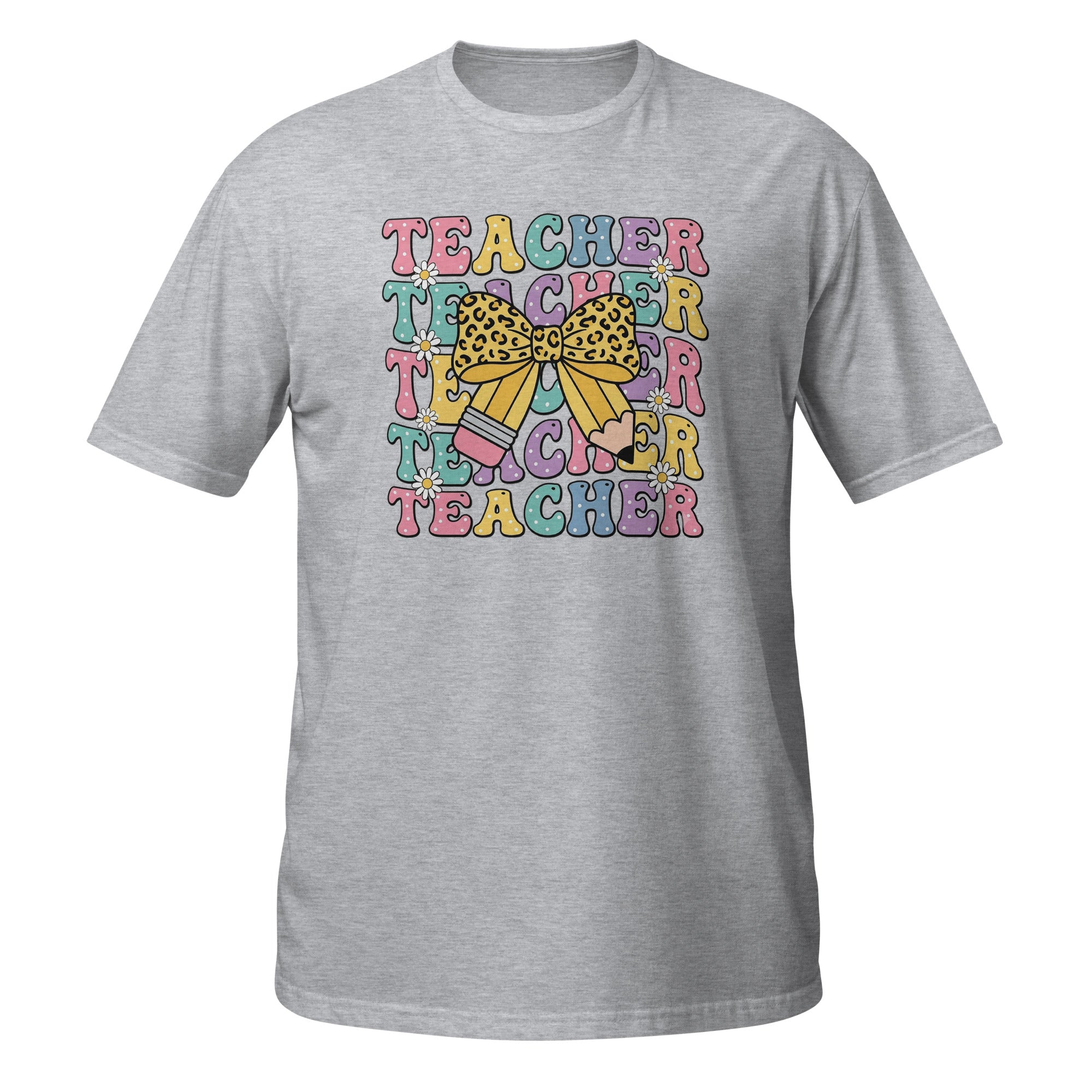 A heather gray short-sleeve crewneck t-shirt featuring a colorful graphic on the chest with the word 'TEACHER' repeated in pastel rainbow letters, overlaid with a yellow leopard-print bow and a pink pencil.