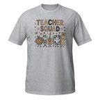 A heather gray short-sleeve t-shirt with a 'TEACHER SQUAD' graphic on the chest, featuring cute cartoon drawings of a leopard-print apple, a checkered pencil, a coffee cup, a cat-shaped highlighter, and a pencil case.