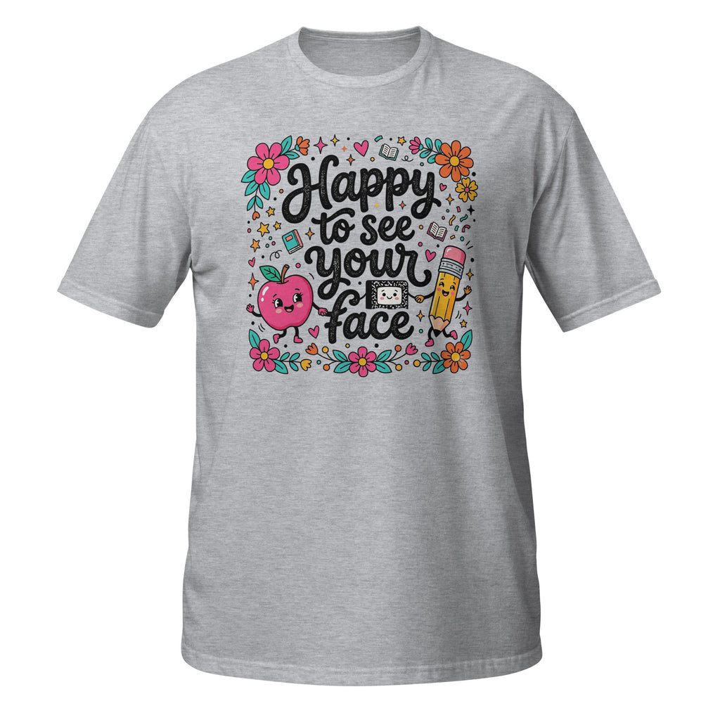 A heather gray short-sleeve t-shirt with a colorful graphic on the front that reads 'Happy to see your face' in black script, surrounded by flowers, a smiling apple, a pencil, and small doodles, shown on a plain white background.