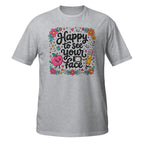 A heather gray short-sleeve t-shirt with a colorful graphic on the front that reads 'Happy to see your face' in black script, surrounded by flowers, a smiling apple, a pencil, and small doodles, shown on a plain white background.